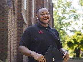 Dylan Foster stands in front of Mauney Hall