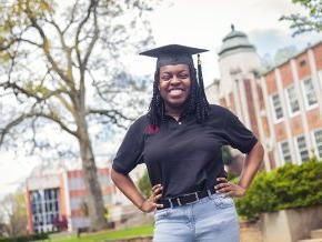 Kiera Elliott standing in front of the Rhyne Building